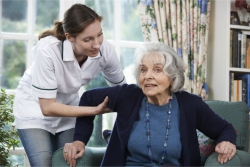 caregiver assisting an elderly woman
